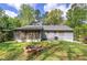 Large grassy backyard with patio and fire pit, perfect for relaxation and entertaining at 5534 Blackhawk Dr, Acworth, GA 30102