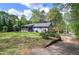 This large backyard is mostly green space and some bushes with a view of the back of the home at 5534 Blackhawk Dr, Acworth, GA 30102