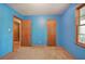 Bright bedroom with carpet flooring, two closets, and a doorway at 5534 Blackhawk Dr, Acworth, GA 30102