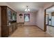 Dining room with hardwood floors, a light fixture, and access to a kitchen area at 5534 Blackhawk Dr, Acworth, GA 30102