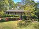 Charming one-story home with beautifully landscaped front yard and stairs leading to covered porch at 5534 Blackhawk Dr, Acworth, GA 30102