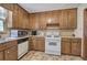 Functional kitchen featuring wooden cabinets and a white stove at 5534 Blackhawk Dr, Acworth, GA 30102