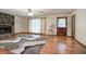 Hardwood floor and stone fireplace in spacious living room with a view to the outside at 5534 Blackhawk Dr, Acworth, GA 30102
