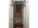Hallway view of an attic access point featuring a pull-down ladder between two doorways at 660 Allens Landing Dr, Lawrenceville, GA 30045