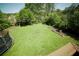 Expansive backyard with green grass, garden beds, and natural surroundings at 660 Allens Landing Dr, Lawrenceville, GA 30045