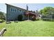 Spacious backyard featuring a wooden deck, mature trees, and a green lawn at 660 Allens Landing Dr, Lawrenceville, GA 30045