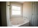 Bathroom features a large soaking tub and window for natural light at 660 Allens Landing Dr, Lawrenceville, GA 30045