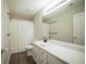 Bathroom featuring dark wood floors, white vanity with granite countertop, and a shower with a curtain at 660 Allens Landing Dr, Lawrenceville, GA 30045