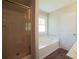 Bathroom with walk-in shower and a large soaking tub for relaxation at 660 Allens Landing Dr, Lawrenceville, GA 30045