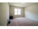 Spacious carpeted bedroom featuring neutral walls and a bright window at 660 Allens Landing Dr, Lawrenceville, GA 30045