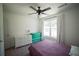 Comfortable bedroom with ceiling fan, window with curtains, and purple bed covering at 660 Allens Landing Dr, Lawrenceville, GA 30045