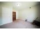 Carpeted bedroom with a built-in bookcase and closet for storage at 660 Allens Landing Dr, Lawrenceville, GA 30045