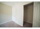 Bedroom with two entryways and plush carpet, featuring view into walk-in closet at 660 Allens Landing Dr, Lawrenceville, GA 30045