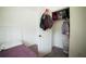 Bedroom closet with personal items hanging and a white laundry basket on the floor at 660 Allens Landing Dr, Lawrenceville, GA 30045