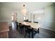 Open-concept dining room featuring a large table, wood floors, and stylish lighting at 660 Allens Landing Dr, Lawrenceville, GA 30045