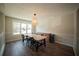 Bright dining room with wood floors, large window, and decorative light fixture at 660 Allens Landing Dr, Lawrenceville, GA 30045
