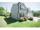 Charming home with a side garden and a walkway to the front entrance at 660 Allens Landing Dr, Lawrenceville, GA 30045
