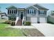 Inviting two-story home with a manicured lawn and a convenient two-car garage at 660 Allens Landing Dr, Lawrenceville, GA 30045