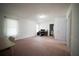 Spacious living room with a computer setup, bathroom, doors, and wall trim throughout at 660 Allens Landing Dr, Lawrenceville, GA 30045