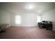 Spacious living room with a computer setup, desk, doors, and wall trim throughout at 660 Allens Landing Dr, Lawrenceville, GA 30045