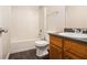 Bathroom with a tub and shower combination, toilet, and vanity with dark countertops at 680 Barshay Dr, Covington, GA 30016