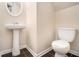 Compact half-bathroom featuring a pedestal sink and tiled flooring at 680 Barshay Dr, Covington, GA 30016