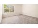Bedroom with a large window with blinds and neutral carpet at 680 Barshay Dr, Covington, GA 30016