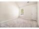 Cozy bedroom featuring neutral carpet, a window, and a door at 680 Barshay Dr, Covington, GA 30016