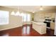 Open kitchen with wood floors, an island, and a breakfast area with a bay window at 988 Vintage Pointe Dr, Lawrenceville, GA 30044