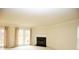Bright living room with a fireplace, French doors to a balcony, and neutral carpet at 988 Vintage Pointe Dr, Lawrenceville, GA 30044