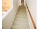 Carpeted stairs with wooden handrail at 988 Vintage Pointe Dr, Lawrenceville, GA 30044