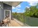 A scenic balcony with a glass railing offers a view of trees and a seating area at 130 Arizona Ne Ave # 214, Atlanta, GA 30307