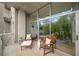 Relaxing outdoor balcony featuring stylish wooden furniture and views through large glass windows at 130 Arizona Ne Ave # 214, Atlanta, GA 30307