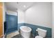 Bathroom with blue tiled shower, soaking tub, and modern toilet at 130 Arizona Ne Ave # 214, Atlanta, GA 30307