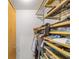 Walk-in closet featuring custom wood shelving and organization system at 130 Arizona Ne Ave # 214, Atlanta, GA 30307