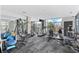 Well-equipped gym with various machines, weights, and large windows providing natural light and views at 130 Arizona Ne Ave # 214, Atlanta, GA 30307
