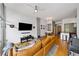 Spacious living room with open floor plan, hardwood floors, leather sofa, and modern decor at 130 Arizona Ne Ave # 214, Atlanta, GA 30307