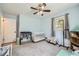 This cozy baby's room boasts a ceiling fan, white crib, changing table and light blue walls at 1461 Sanden Ferry Dr, Decatur, GA 30033