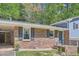 Close-up of a well-maintained home with brick facade, black shutters, and a charming front entrance at 1461 Sanden Ferry Dr, Decatur, GA 30033