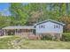 Charming two-story home with light blue siding, brick facade and mature landscaping at 1461 Sanden Ferry Dr, Decatur, GA 30033