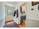 A hallway with an entrance door, built-in coat rack, and views into the adjacent kitchen at 1461 Sanden Ferry Dr, Decatur, GA 30033