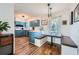 A cheerful kitchen has painted cabinets, hardwood floors, a breakfast nook with bench seating and modern light fixtures at 1461 Sanden Ferry Dr, Decatur, GA 30033