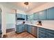 This kitchen features painted cabinets, stainless steel appliances, white countertops, and hardwood floors at 1461 Sanden Ferry Dr, Decatur, GA 30033