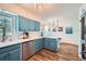 The kitchen has painted cabinets, stainless steel appliances, white countertops and hardwood floors at 1461 Sanden Ferry Dr, Decatur, GA 30033