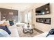 Well-lit living room featuring a modern fireplace and comfortable sofa with accent pillows at 149 Weldon Rd, Mcdonough, GA 30253