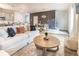 Open-concept living area with a gray accent wall, dining table, and modern lighting at 149 Weldon Rd, Mcdonough, GA 30253