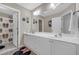Well-lit bathroom featuring a double vanity and a Mickey Mouse themed shower curtain at 1549 Tappahannock Trl, Marietta, GA 30062