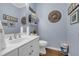 Bathroom with football team decoration, clean vanity with good lighting, and tiled flooring at 1549 Tappahannock Trl, Marietta, GA 30062