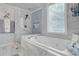 Well lit bathroom featuring a jetted tub, shower, and stylish tile at 1549 Tappahannock Trl, Marietta, GA 30062
