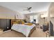 Well-lit bedroom featuring a wooden bed frame, patterned wallpaper, and a ceiling fan at 1549 Tappahannock Trl, Marietta, GA 30062